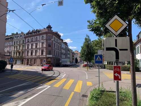 Kreuzung Riehenstrasse Ecke Hammerstrasse in Basel aus Sicht eines Radfahrers, auf der Riehenstrasse von der Messe her kommend